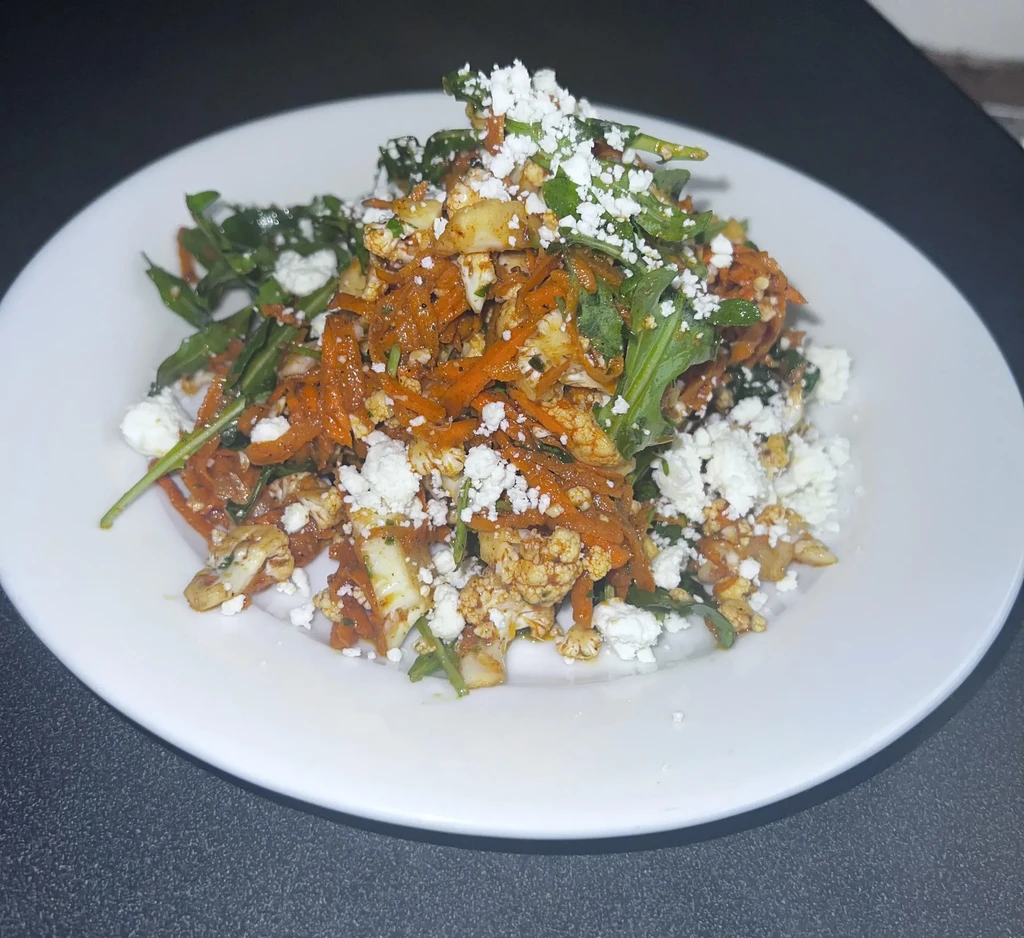 Colorful vegetable medley with carrots, roasted cauliflower, and crumbled feta.