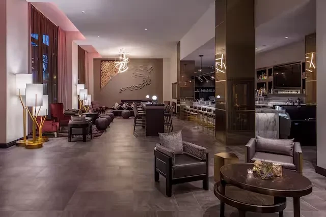 Modern, upscale lounge and bar with warm lighting and abstract art.
