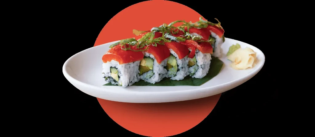Seven inside-out sushi rolls topped with tuna, ginger, and wasabi.
