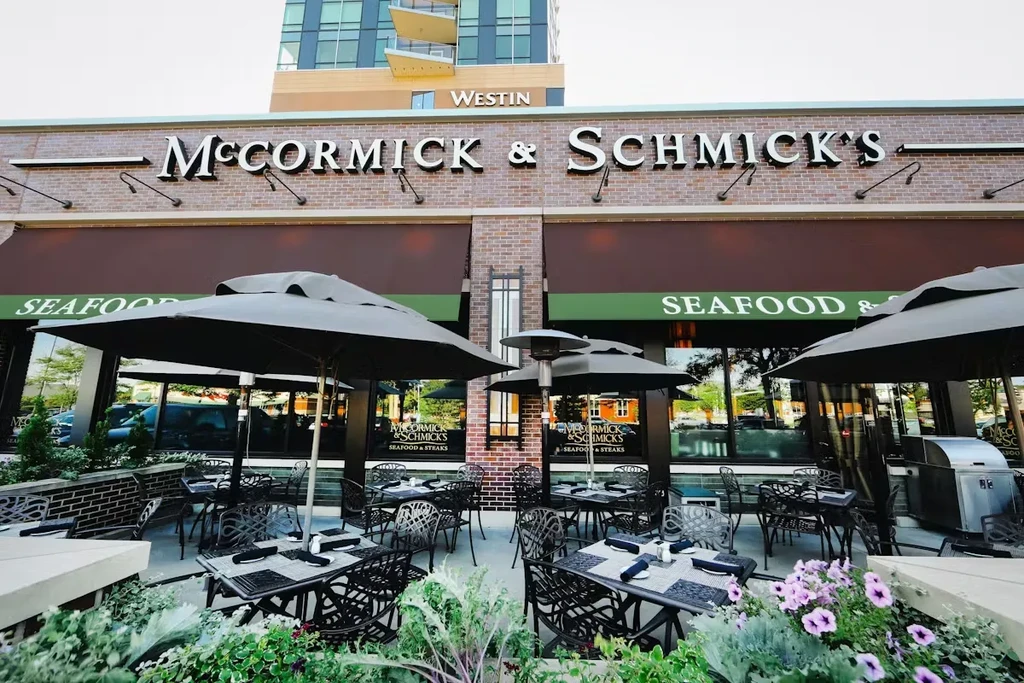 McCormick & Schmick's seafood restaurant exterior with patio tables and umbrellas.