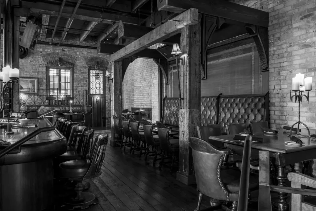 Empty black and white rustic restaurant interior with soft lighting.