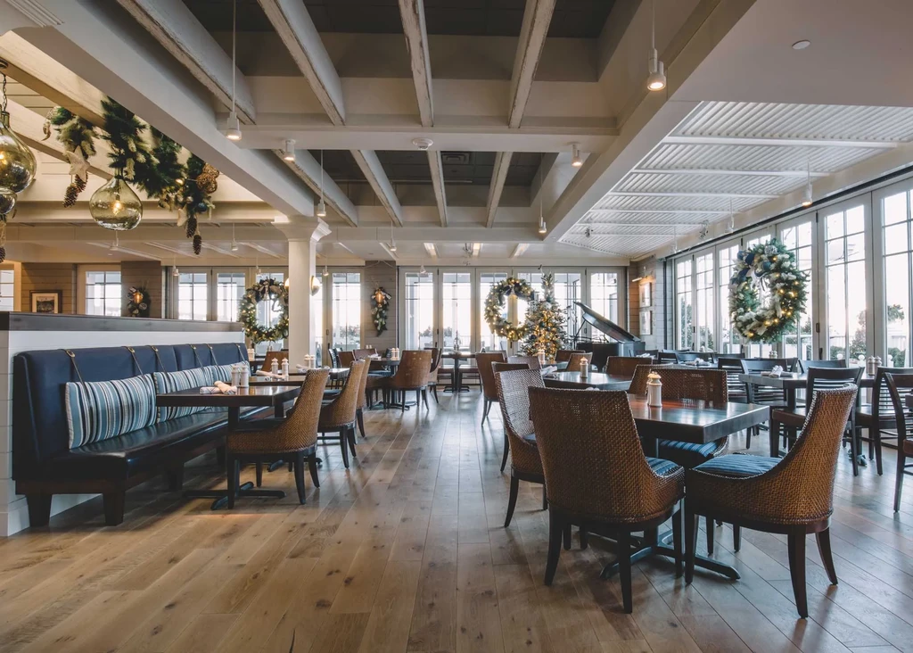 Elegant restaurant dining room with festive holiday decorations.