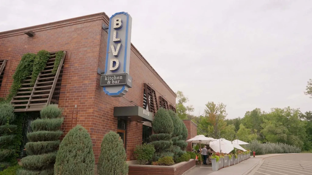 Brick BLVD kitchen & bar building with outdoor patio and ivy.