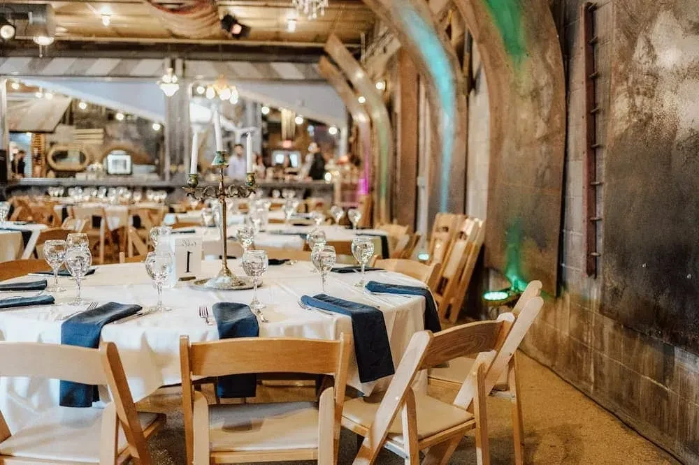 Elegant dining venue with set tables and arched structures.