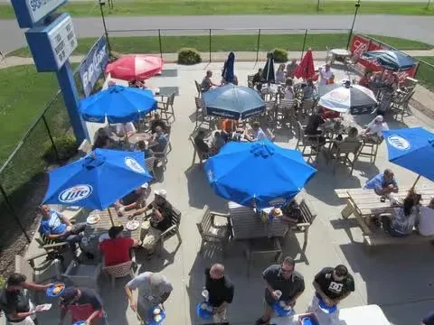 Overhead view of a busy sports bar patio with Miller Lite umbrellas.