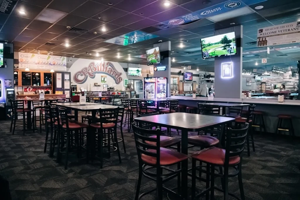 Interior of CR Billiards with high-top tables, TVs, and bars.