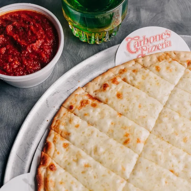 Carbone's Pizzeria cheesy bread, marinara, and a green drink.
