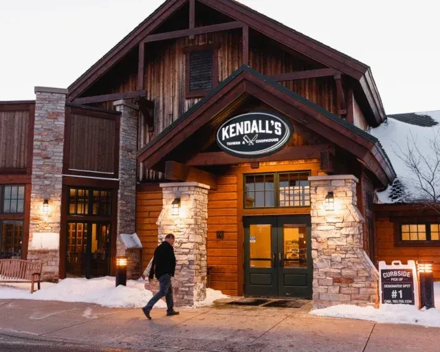 Kendall's Tavern & Chophouse exterior: rustic lodge building in winter snow.