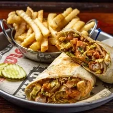 Chicken wrap meal with fries and pickles on a metal tray.