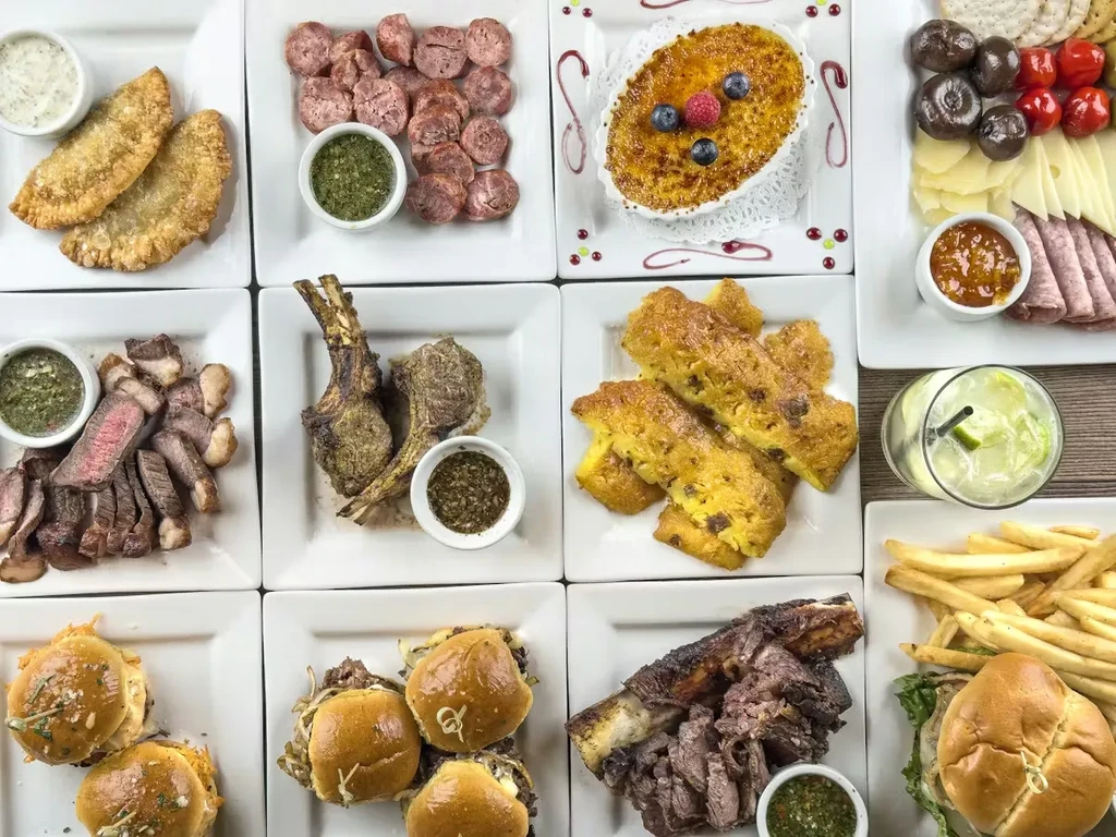 Overhead grid of twelve diverse food dishes and a cocktail.