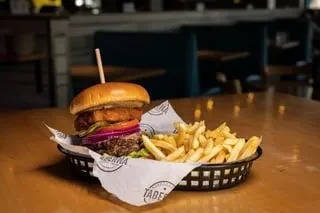 Gourmet burger and crispy fries served in a restaurant.