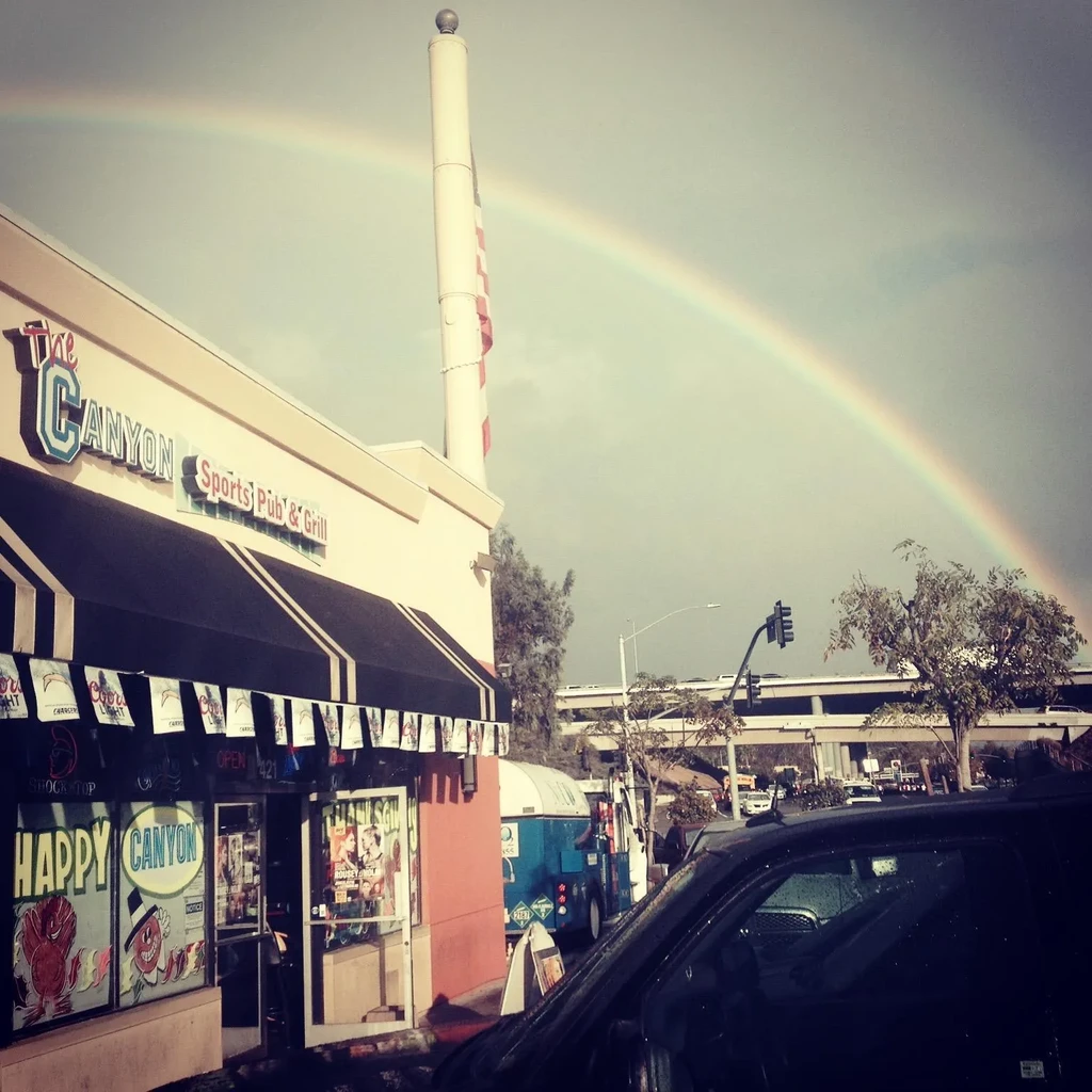 Vivid rainbow arches over The Canyon Sports Pub & Grill.
