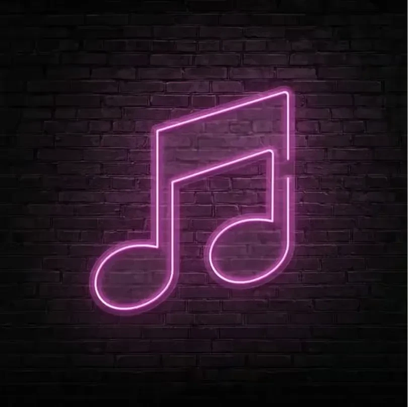 Bright pink neon double musical note on a dark brick wall.