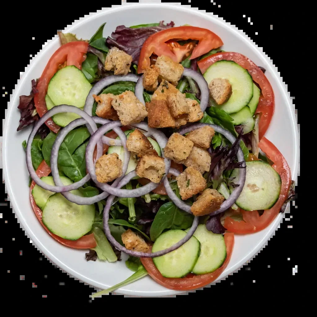 Fresh mixed green salad with tomatoes, cucumber, onion, and croutons.