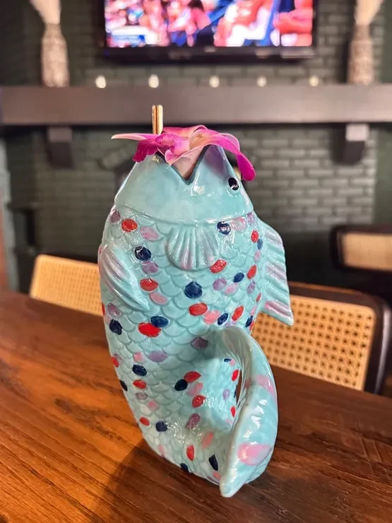 Ceramic light blue fish cocktail mug with colorful scales and flower.