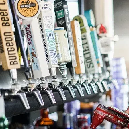 Row of diverse beer tap handles from various breweries.