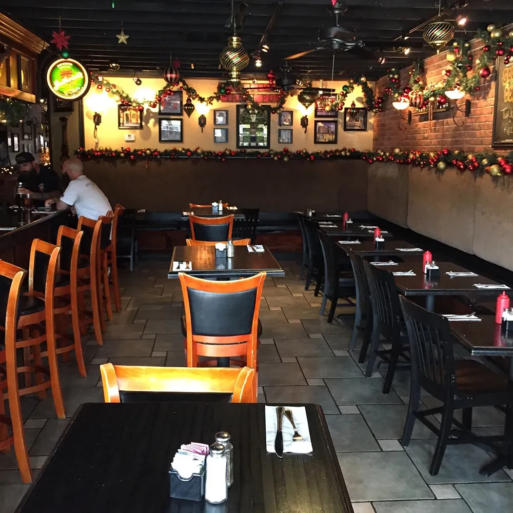 Warmly lit, cozy restaurant and bar with extensive holiday decor.