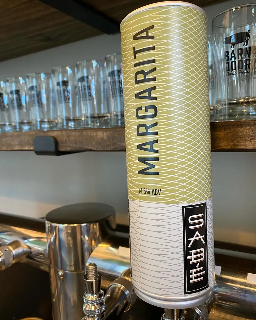 Olive green Margarita tap handle for SABAE at a bar.
