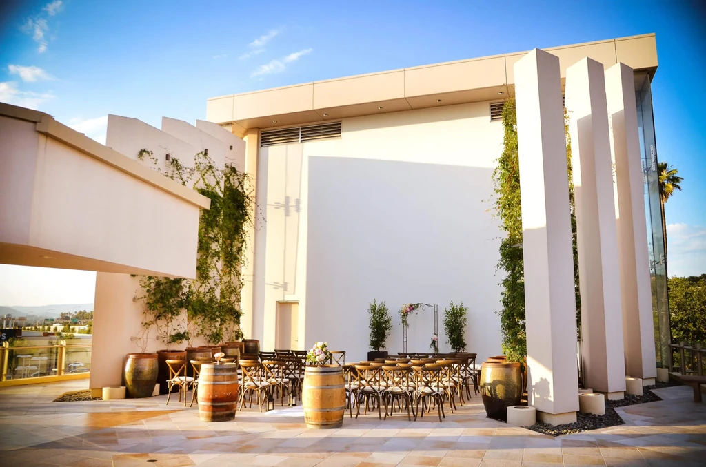 THOUGHTS:
The user wants an alt-text for an image description.
It needs to be:
- Short (7-12 words)
- Factual
- No marketing language
- Concise and descriptive
- Return ONLY the alt text.

Image description breakdown:
- Outdoor event space/terrace, possibl