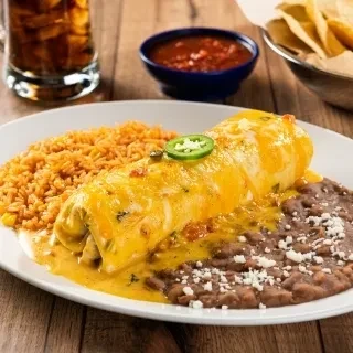 Burrito covered in melted cheese, with rice, beans, and jalapeños.