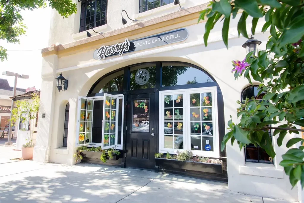 Exterior of Harry's SPORTS BAR & GRILL on a sunny day.
