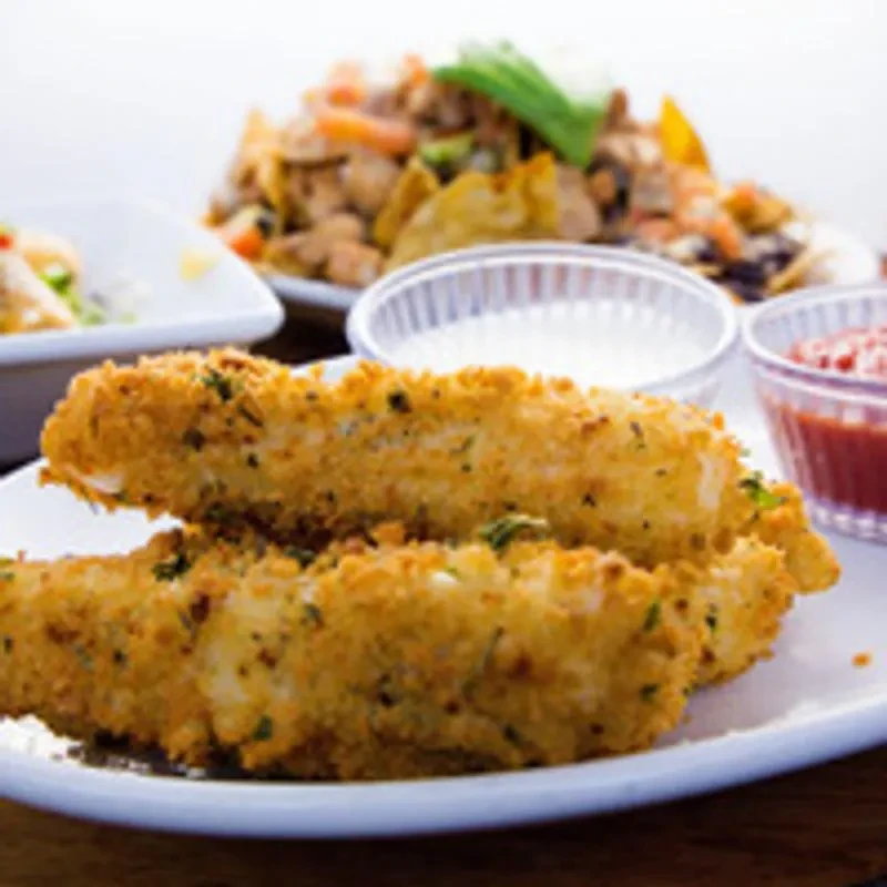 Two crispy, breaded food sticks with green herbs and two dips.