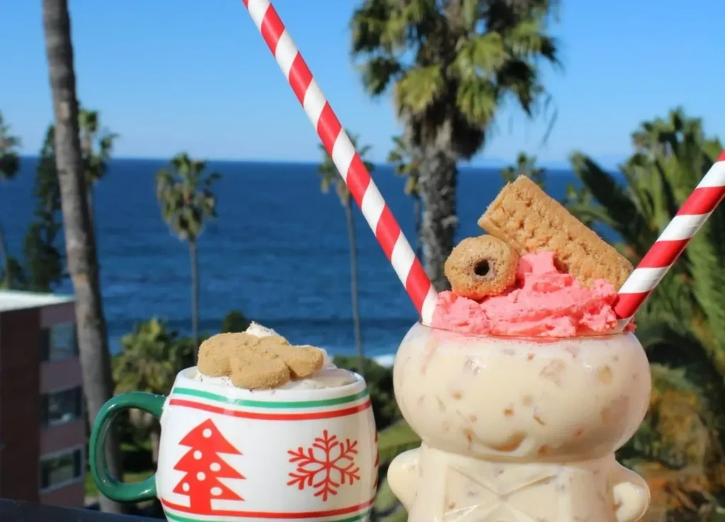 Two festive, elaborately garnished drinks with a tropical ocean background.