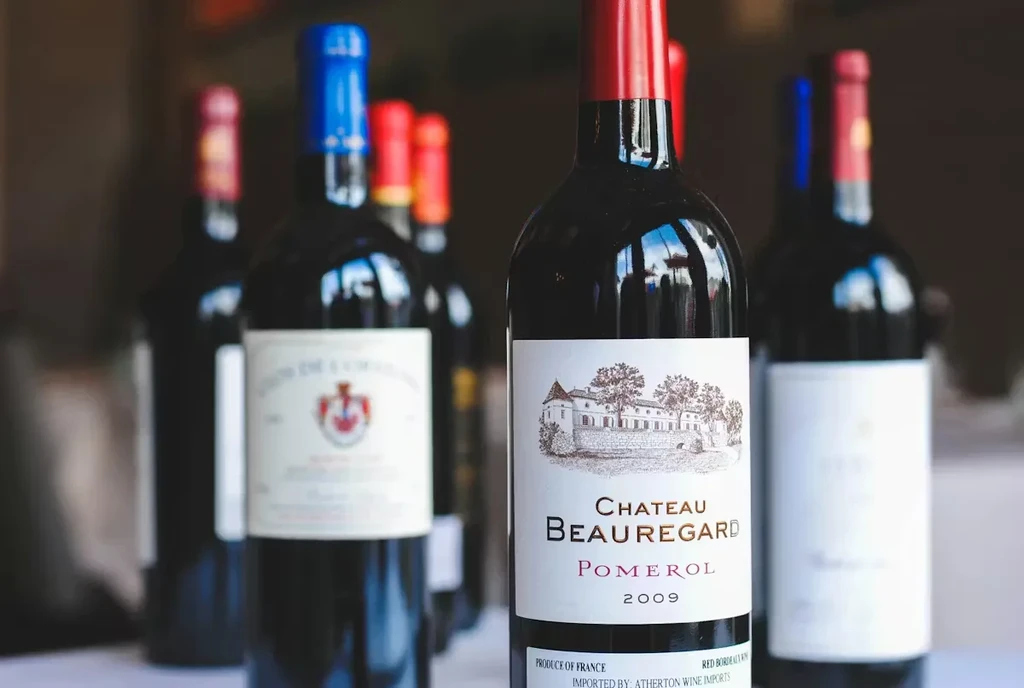 Sharp focus on Chateau Beauregard Pomerol 2009 wine bottle, blurred bottles.
