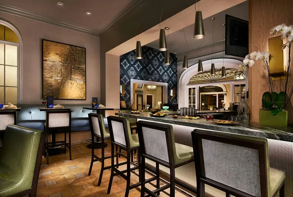 Elegant, empty restaurant bar with stylish seating, cocktails, and modern decor.