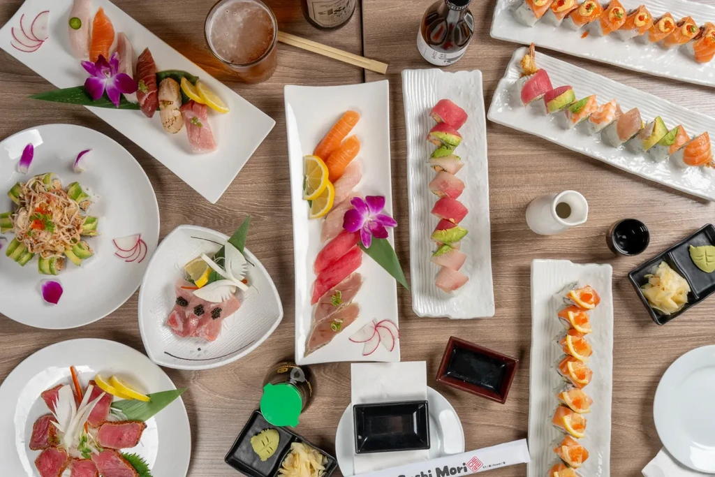 Overhead view of an extensive spread of Japanese sushi and sashimi.