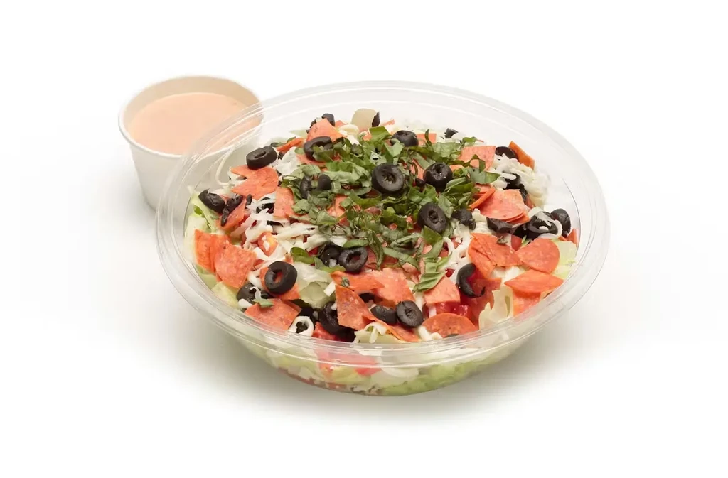 To-go pepperoni salad with cheese, tomatoes, olives, and separate dressing.
