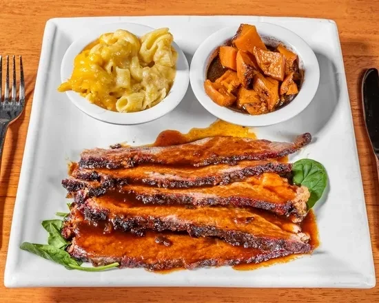 Top-down view: sauced meat, mac and cheese, candied yams.