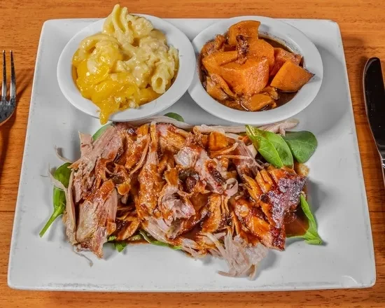 Plated shredded meat, spinach, mac and cheese, and sweet potatoes.