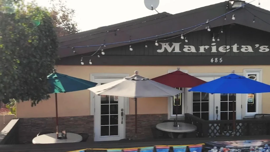 Marieta's restaurant facade and patio with multiple colorful umbrellas.
