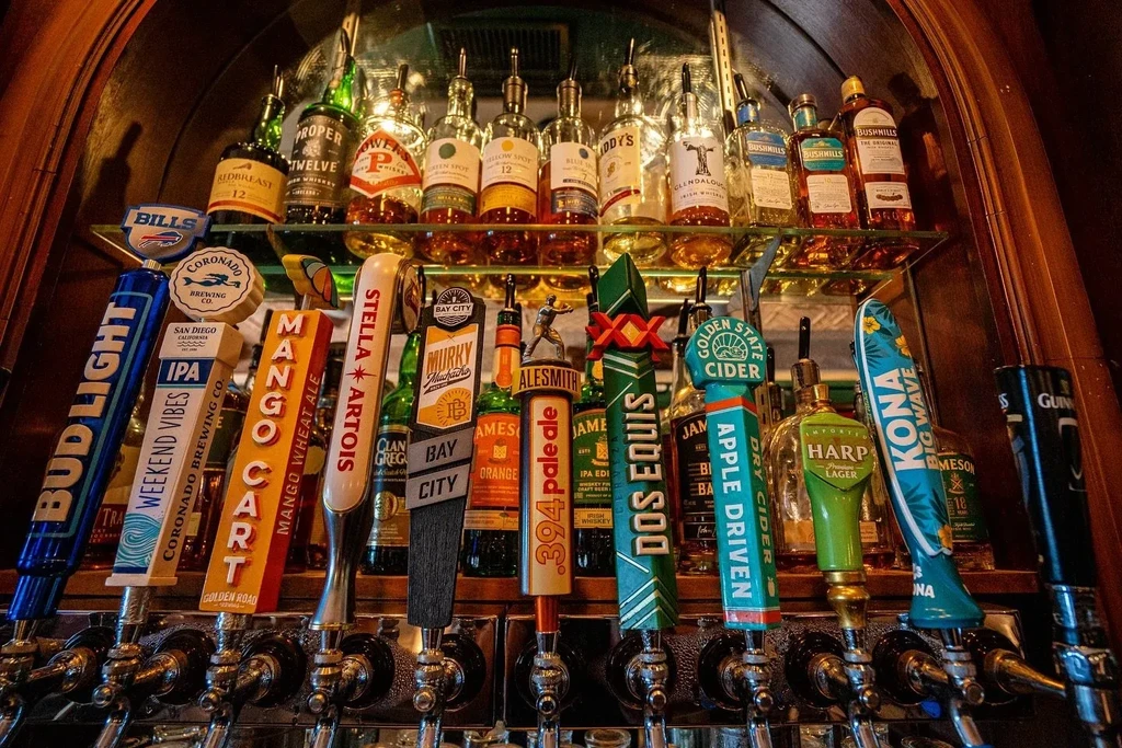 Well-stocked bar with various beer taps and rows of spirit bottles.
