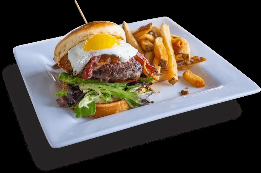 Open-faced burger with egg, bacon, cheese, and golden french fries.