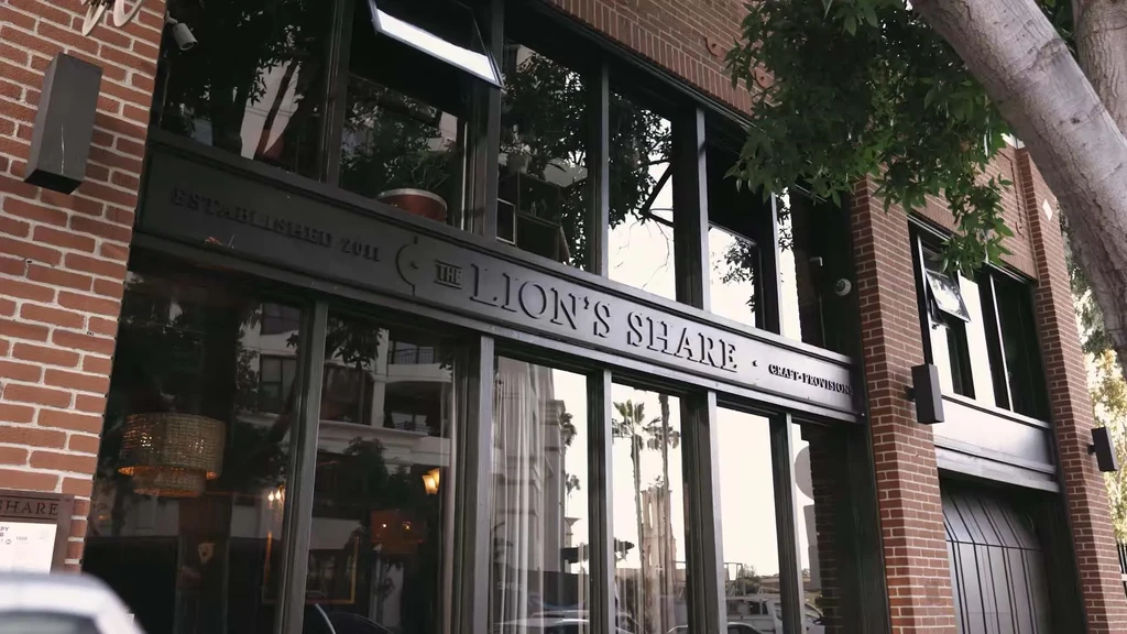 The Lion's Share restaurant exterior with red brick and reflective windows.