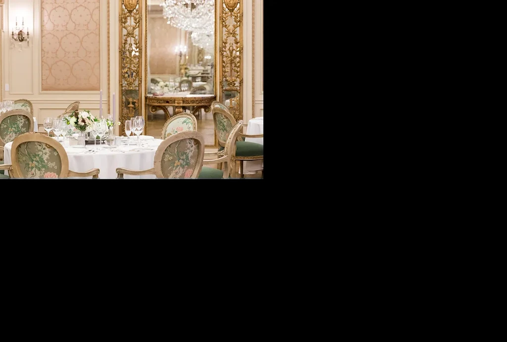 Luxurious restaurant interior features a set dining table and grand decor.