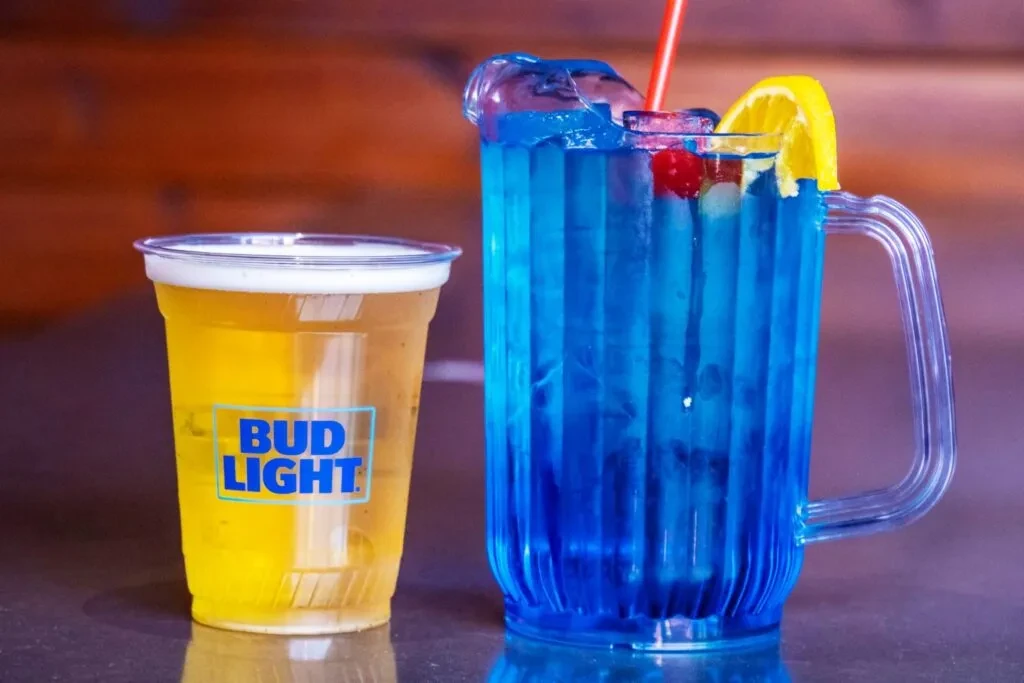 Bud Light beer and a blue drink with fruit garnishes.