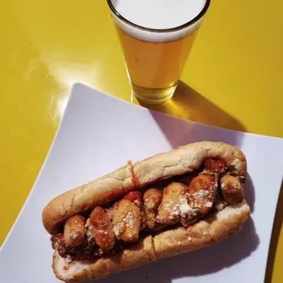 Fried item sub sandwich with red sauce, cheese, and beer.