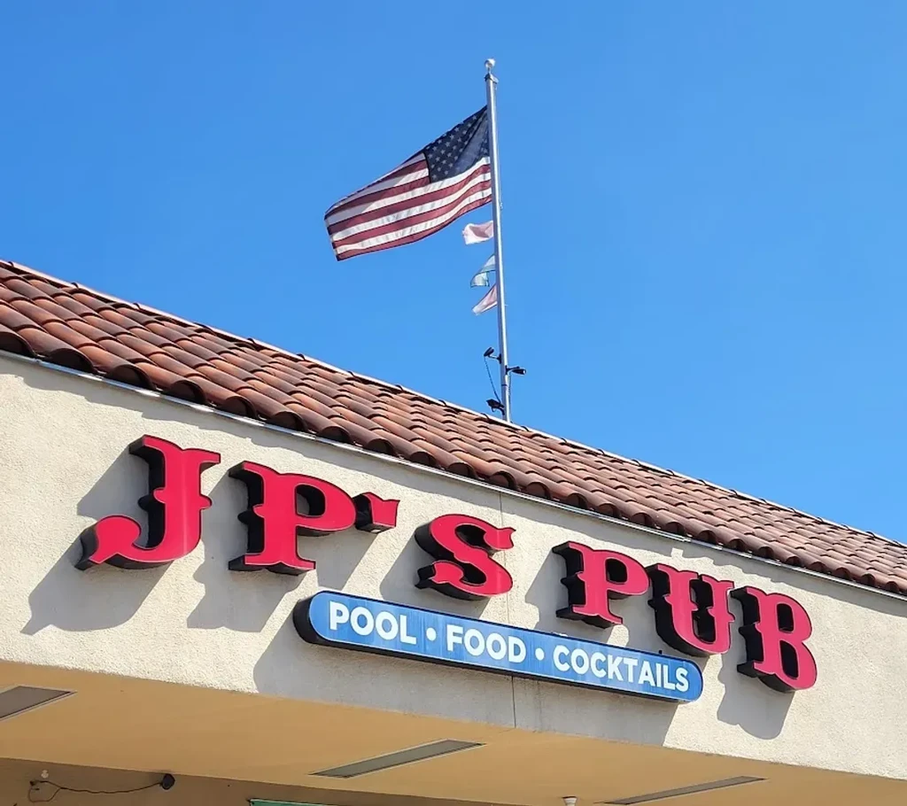 JP's PUB building with a prominent red sign and American flag.