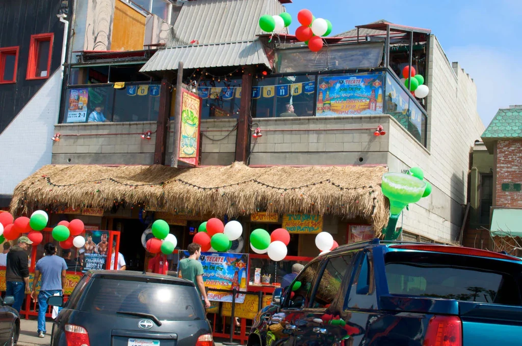 Multi-story Mexican restaurant exterior with festive balloons and inflatable margarita.