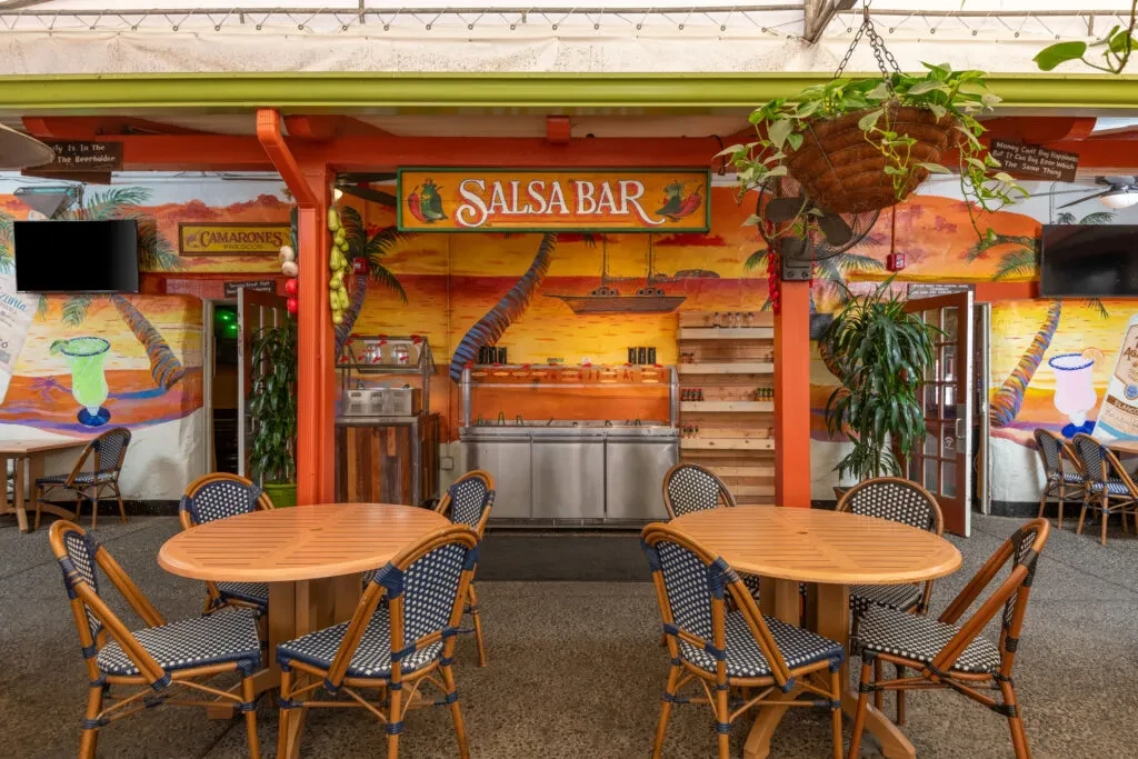 Colorful Mexican restaurant patio with a salsa bar and beach murals.