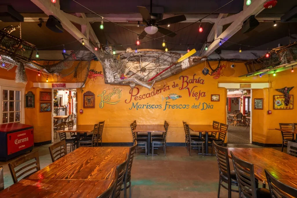 Empty Lopez seafood restaurant interior with yellow walls and nautical decor.