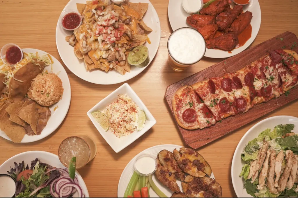 Overhead shot of a table full of appetizers and drinks.