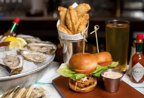 Oysters on ice, mini-burgers, fried snacks, beer, and Tabasco sauce.