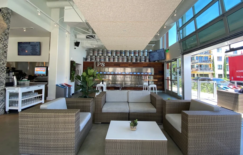 Spacious, modern taproom with a prominent self-pour beer wall and lounge seating.