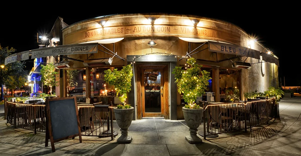 Bleu Boheme French restaurant exterior at night, warmly lit with patio.