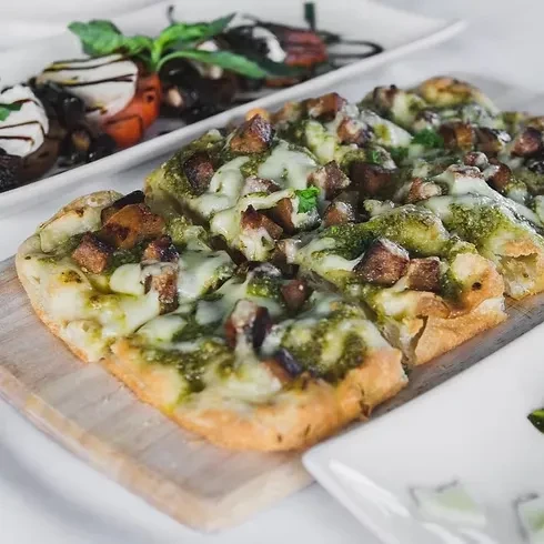 Pesto focaccia with meat and cheese; roasted tomatoes with balsamic glaze.