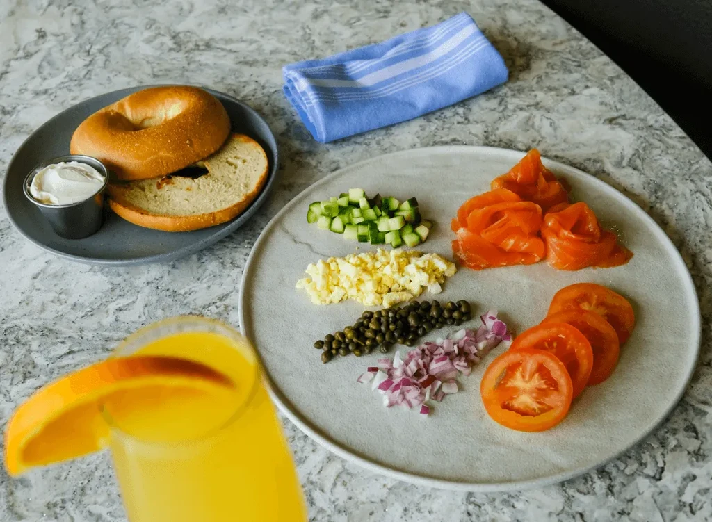 Overhead shot of a bagel brunch spread with salmon and fresh toppings.